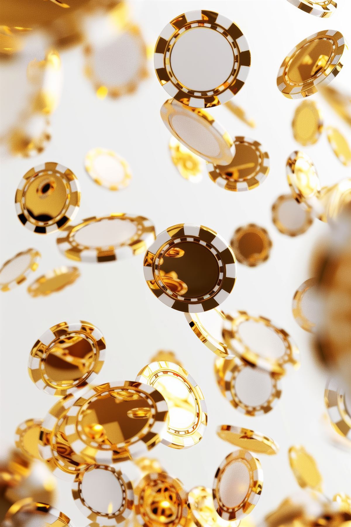 Gold and white casino chips falling through soft light